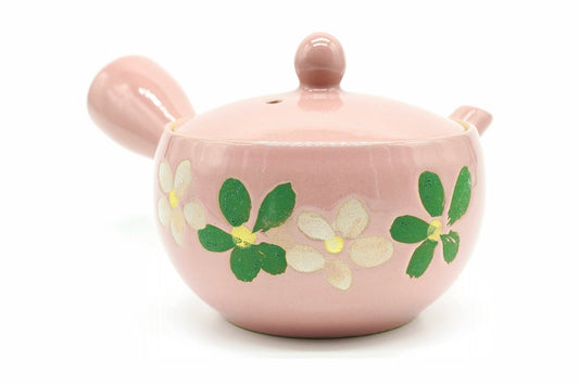Momoiro Kyusu seen from the front, a garland of white flowers and green leaves around the body