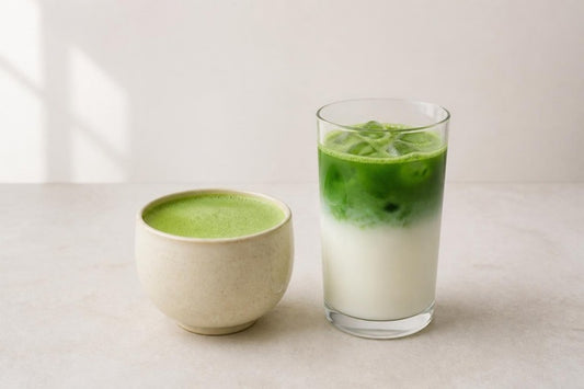 A hot matcha latte in a cream ceramic cup beside an iced matcha latte in a tall glass, EdoMatcha