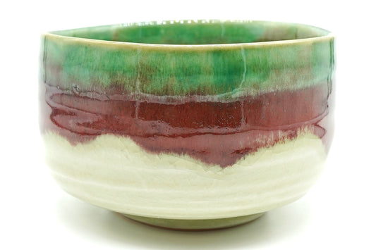 Karamine Chawan, a Mino ware matcha bowl with a crackled cream base, a copper-red band and a bright green glaze at the rim