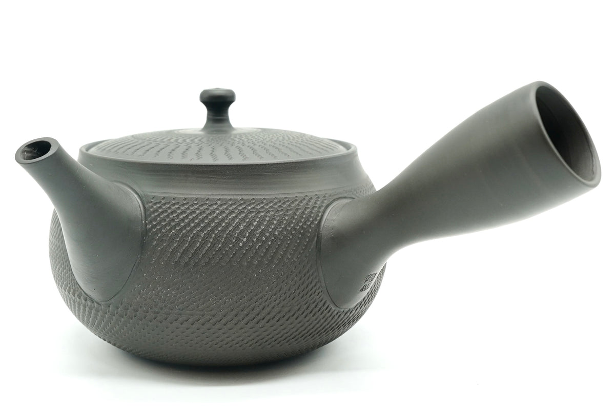 Rikyu Nezumi kyusu, side view, unglazed grey-green clay with fine carved chatter marks over the body and lid