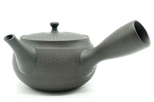 Rikyu Nezumi kyusu, side view, unglazed grey-green clay with fine carved chatter marks over the body and lid