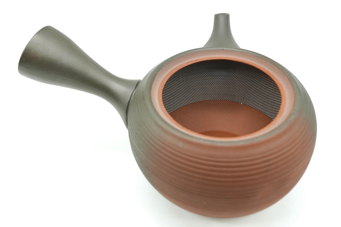 Hinode Kyusu with the lid off, showing the obi-ami stainless mesh band around the inside wall and the red clay interior