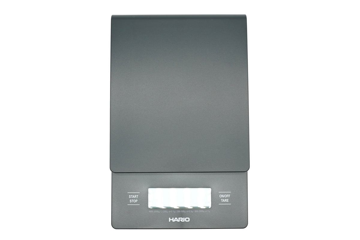 Hario V60 Drip Scale in black, top view showing the weighing platform, timer and weight display, and the start, stop and tare buttons