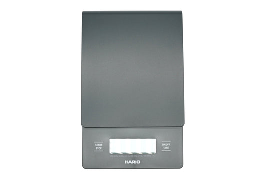 Hario V60 Drip Scale in black, top view showing the weighing platform, timer and weight display, and the start, stop and tare buttons