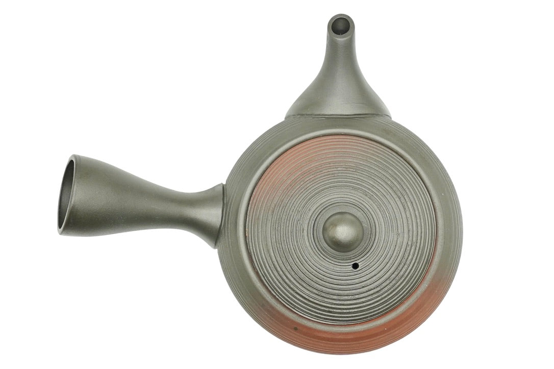Hinode Kyusu seen from above, the dark ridged lid with red clay glowing through the rings