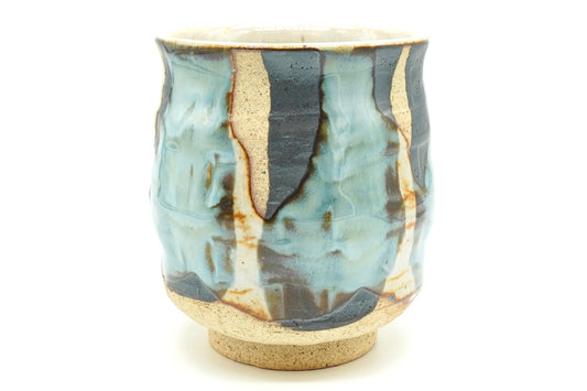 Sushi Yunomi, a tall Mino ware teacup with pale blue and cream glaze poured over dark iron-brown patches on sandy clay