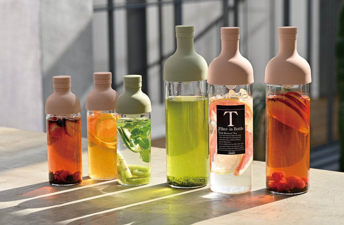 HARIO Filter-in Bottles in 300ml and 750ml, smoky green and smoky pink, filled with fruit teas and cold-brewed sencha in the sun