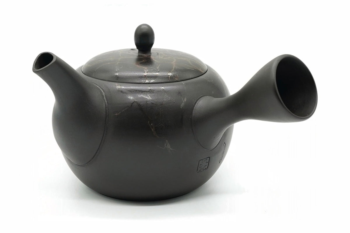 Gyokko Kyusu, a Tokoname teapot with a matte black body and a lid veined in copper-red and silver, side view