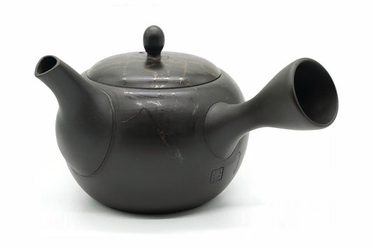 Gyokko Kyusu, a Tokoname teapot with a matte black body and a lid veined in copper-red and silver, side view