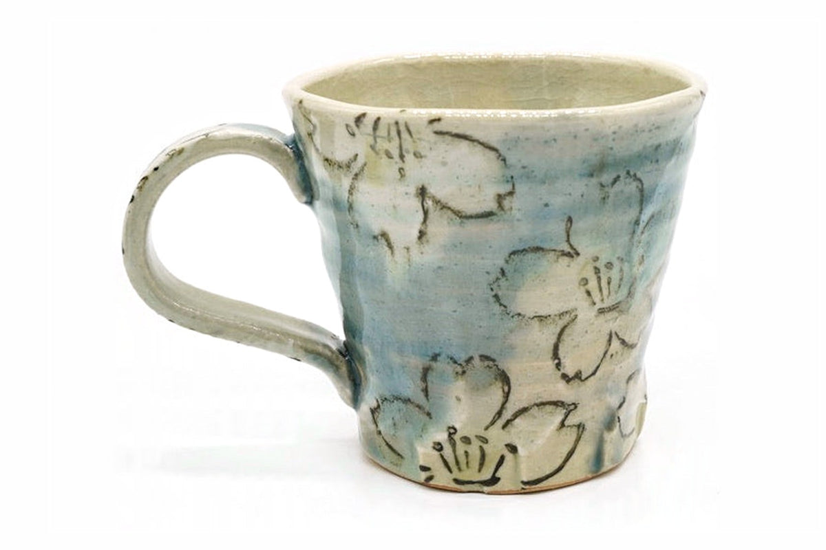 Hakka Yunomi, a blue-green Mino ware mug with a handle and white blossoms drawn in outline