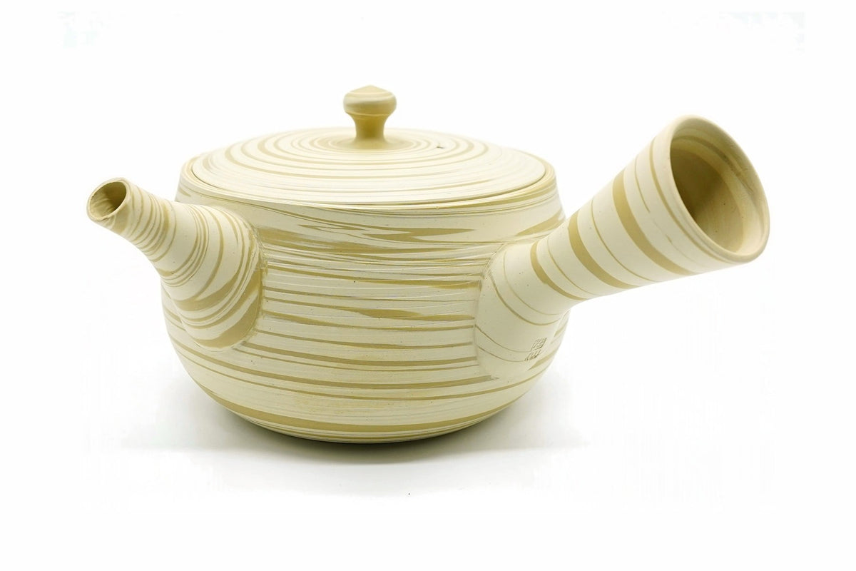 Hakuo Kyusu, a cream Tokoname teapot with sandy tan swirls running through the clay, side view