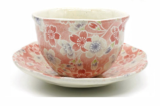 Sakura Yunomi, a Mino ware cup covered in pink and white cherry blossoms on a red ground, on its matching saucer