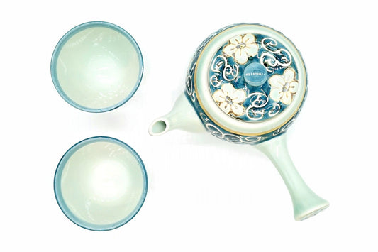 Hana-Karakusa Japanese Tea Set from above, the kyusu with flowers and scrolls on its lid and the two cups, pale blue-green inside