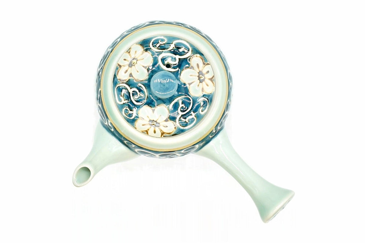 Hana-Karakusa Kyusu from above, pale flowers and white scrolls on the blue lid, with the pale blue-green spout and handle