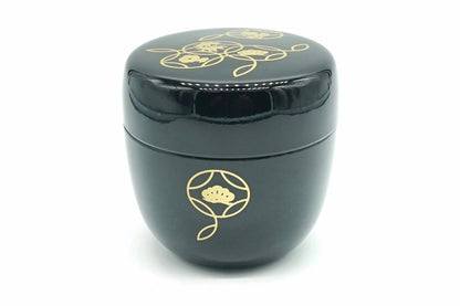 Hana-Shippō Natsume in black, a glossy matcha caddy with gold linked circles on the lid and one gold circle with pine on the body