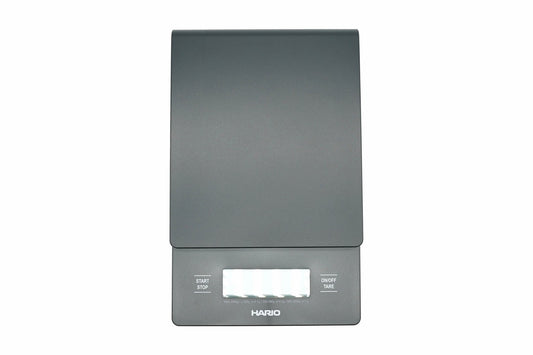 Hario V60 Drip Scale in black, top view showing the weighing platform, timer and weight display, and the start, stop and tare buttons
