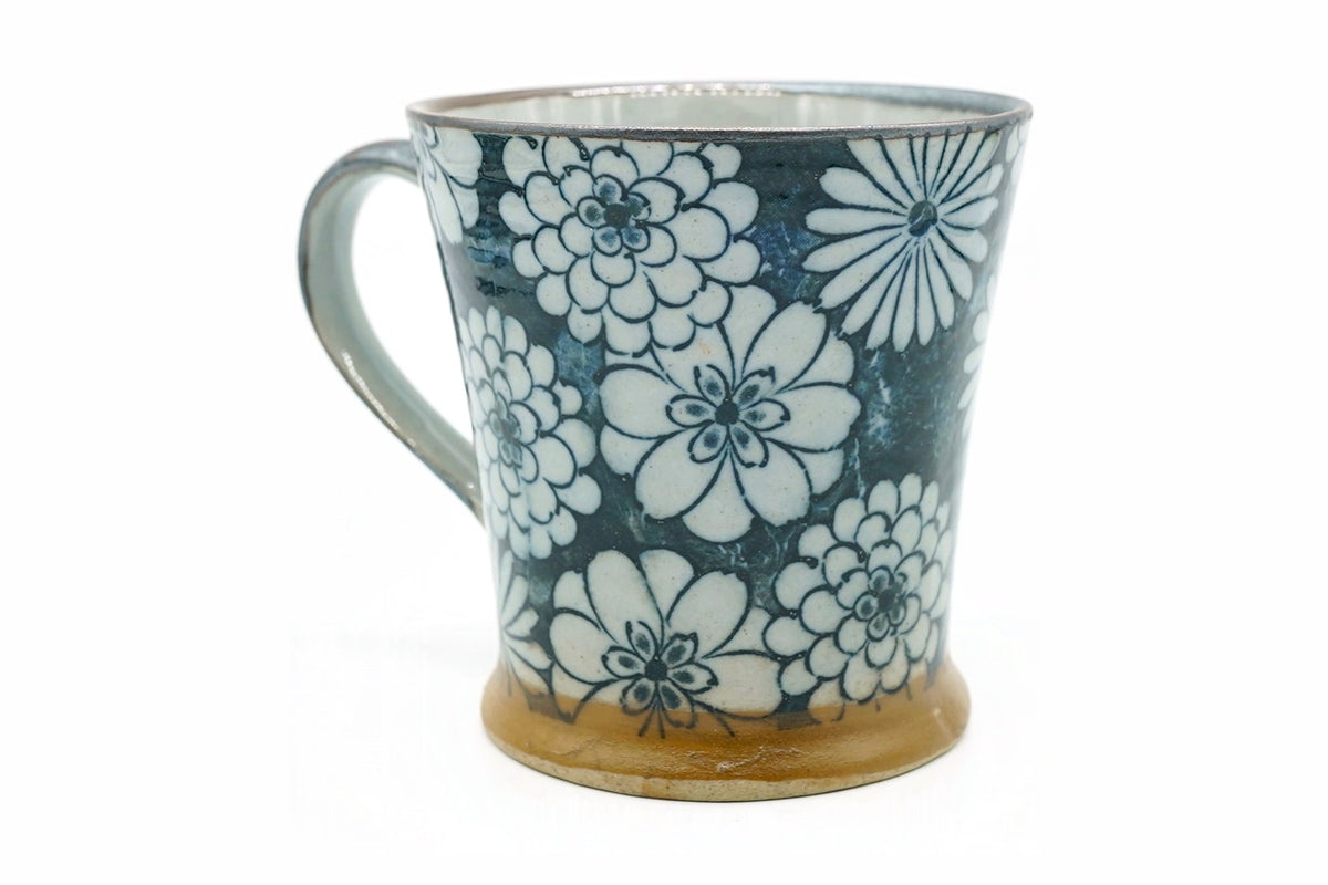 Hyakka Yunomi, a Mino ware cup with a handle, covered in white chrysanthemums over deep blue, front view, EdoMatcha Sydney