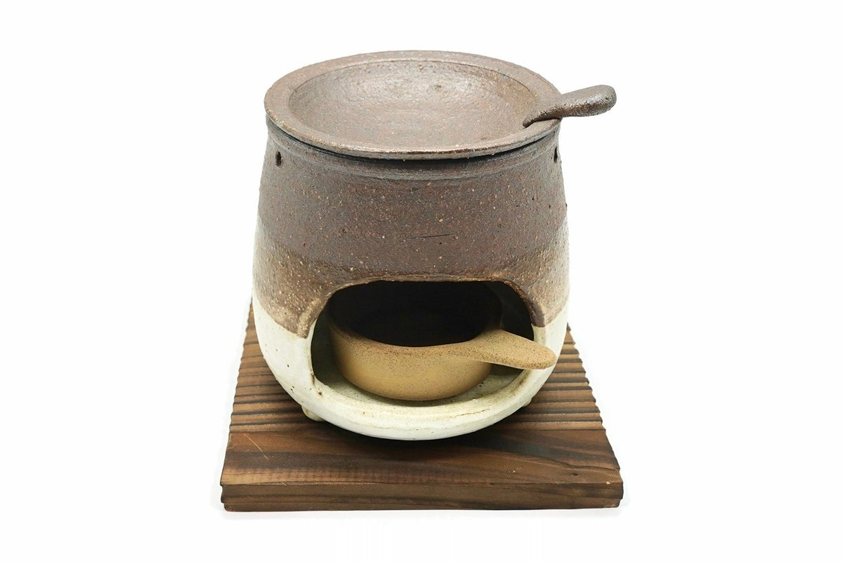 Kakewake Cha-kōro, a brown and white tea incense burner with a tab-handled dish on top, shown on a wooden board that is not included