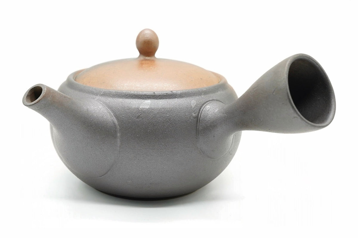 Kaki Kyusu, a Tokoname teapot half bare orange-tan clay and half smoky metallic glaze, side view