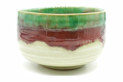Karamine Chawan, a Mino ware matcha bowl with a crackled cream base, a copper-red band and a bright green glaze at the rim