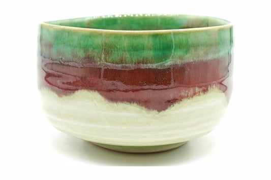 Karamine Chawan, a Mino ware matcha bowl with a crackled cream base, a copper-red band and a bright green glaze at the rim