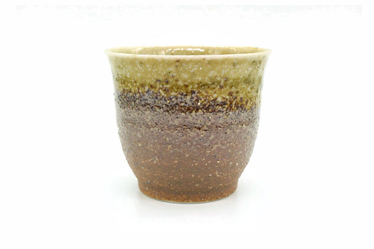 Kazan Yunomi, a rough Mino ware teacup graded from pale olive at the rim to rust brown at the foot, front view