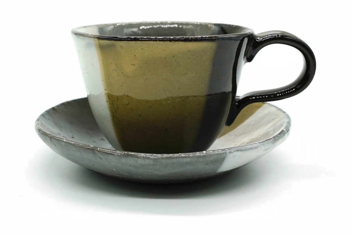 Kiame Yunomi, a Mino ware cup and saucer glazed in wedges of mustard yellow, grey-white and charcoal, front view