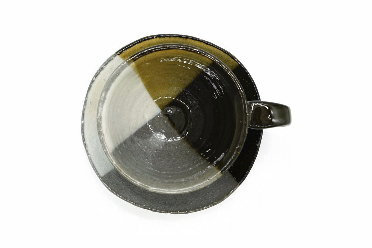Kiame Yunomi from above, the three glazes continuing inside the cup and across the saucer