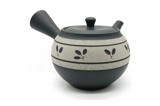Kibō Kyusu, a black Tokoname teapot with a sandy speckled band painted with small leaves, front view