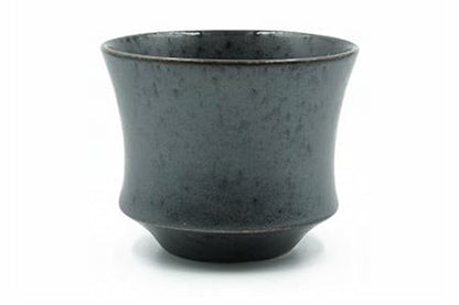 Kuro Yunomi, a matte charcoal-black Mino ware teacup flaring from a stepped foot, front view