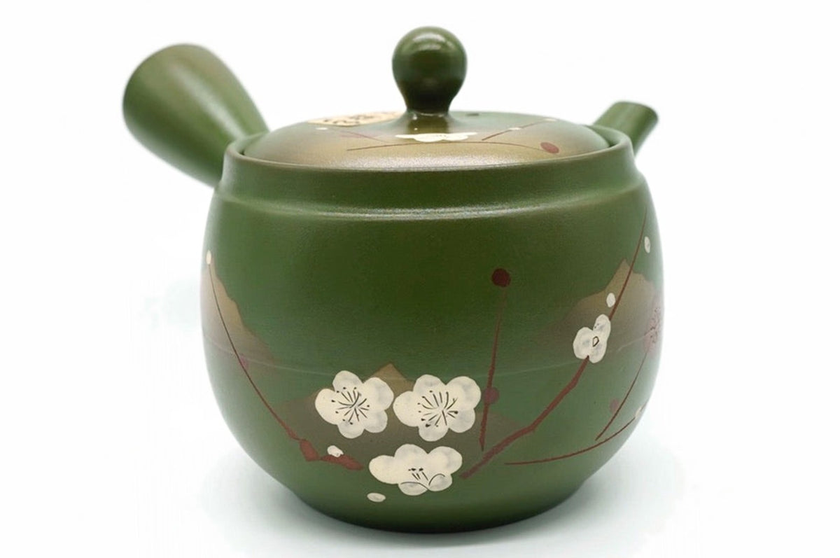 Midori Kyusu, an olive-green Tokoname teapot hand-painted with white plum blossoms and a gold mountain, front view