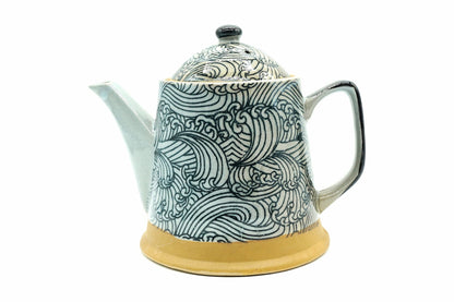 Miryō Kyusu, a white Mino ware teapot covered in dark blue-green waves, with a handle at the back, side view