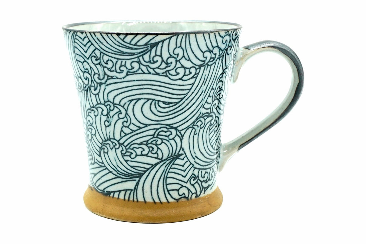 Miryō Yunomi, a white Mino ware mug covered in drawn blue-green waves, with a dark handle, front view
