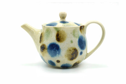 Mizutama Kyusu, a cream Tokoname teapot with large blue, brown and green polka dots and a loop handle at the back