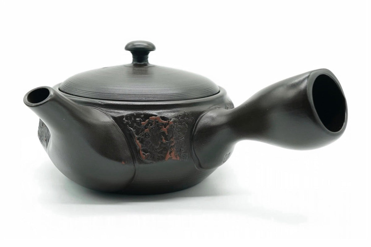 Mokume Kyusu, a dark Tokoname teapot with a rough red-brown panel and a red-tipped knob, side view