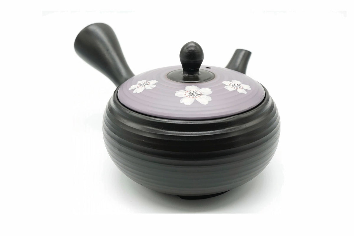 Murasaki Kyusu, a black ribbed Tokoname teapot with a lavender lid of white cherry blossoms, front view
