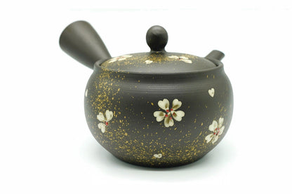 Nadeshiko Kyusu, a black Tokoname teapot flecked with gold and painted with white dianthus flowers, side view