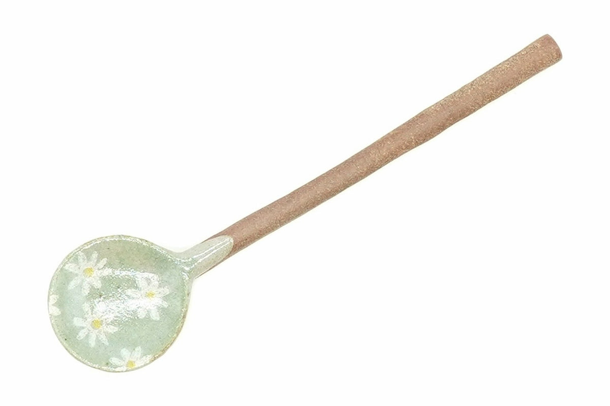 Nobana Ceramic Tea Spoon from above, the pale green bowl with white daisy-like flowers and the long clay handle