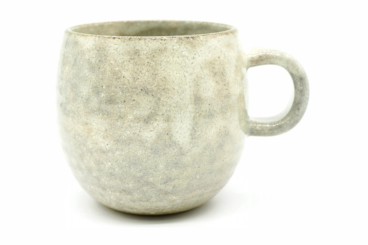 Nukumori Yunomi, a big round Mino ware mug in a pale grey-cream speckled glaze, front view