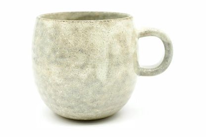 Nukumori Yunomi, a big round Mino ware mug in a pale grey-cream speckled glaze, front view