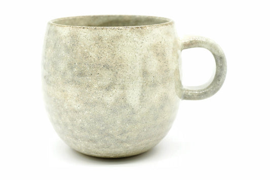 Nukumori Yunomi, a big round Mino ware mug in a pale grey-cream speckled glaze, front view