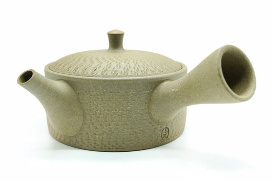 Ori Kyusu, a bare clay Tokoname teapot pressed all over with a fine woven texture, side view