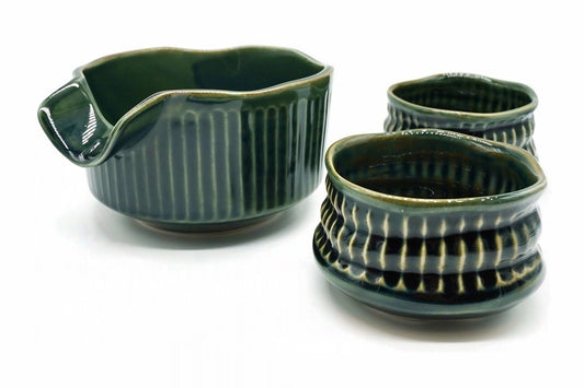 Oribe Japanese Tea Set: the deep green spouted matcha bowl with fine vertical ribs beside the two Oribe Hime cups with wavy rims