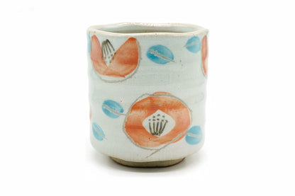 Sachi Yunomi, a tall pale grooved Mino ware teacup hand-painted with orange flowers and blue leaves, front view