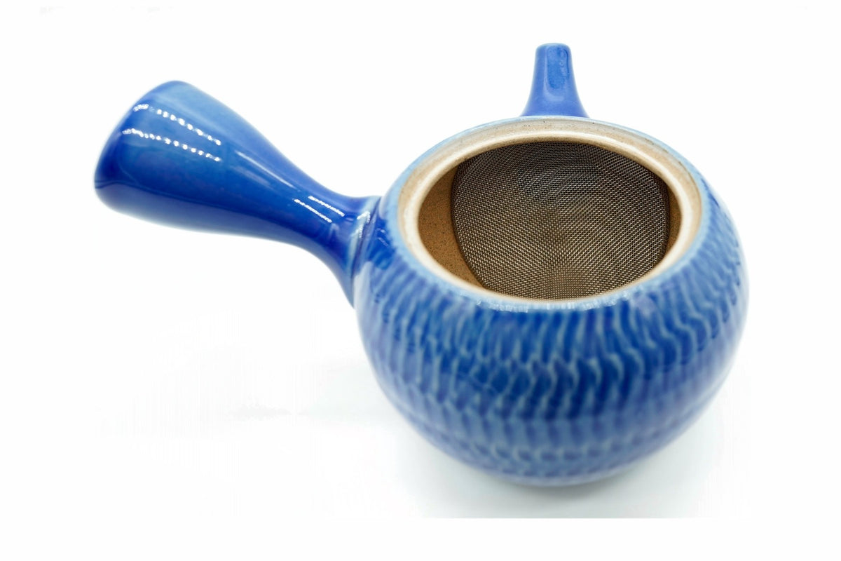 Seigyoku Kyusu with the lid off, the curved stainless mesh over the spout opening and bare tan clay inside