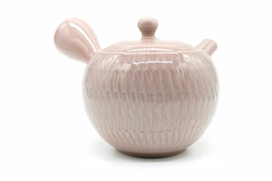 Sekimen Kyusu seen from the front, the glossy pink glaze over the chattered body
