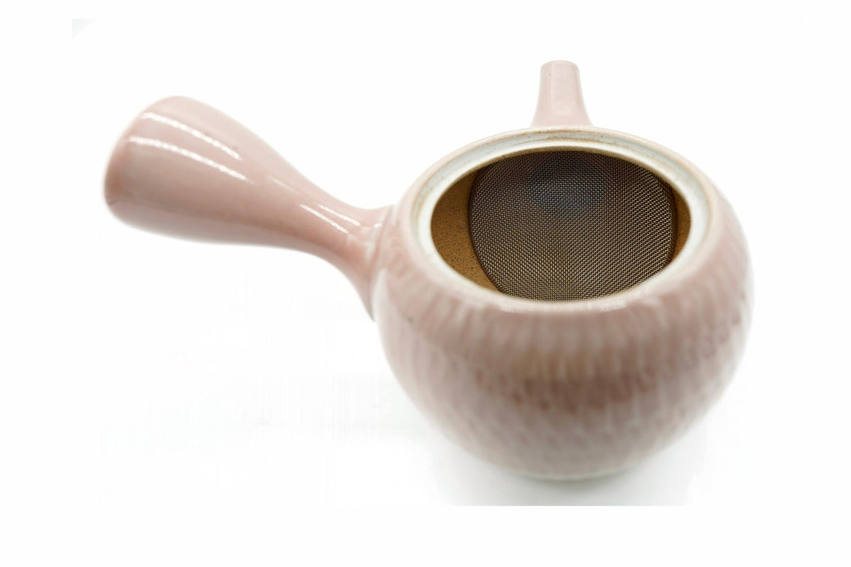 Sekimen Kyusu with the lid off, the curved stainless mesh over the spout opening and bare tan clay inside