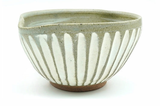 Shiro-Tokusa Katakuchi Chawan, a spouted Mino ware matcha bowl in speckled grey-green glaze with white vertical stripes and a bare brown foot