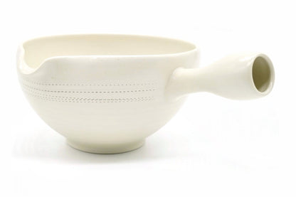 Shiro Yuzamashi, a white open bowl with a pouring lip, a hollow side handle and a band of fine dots, seen from the side