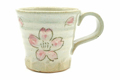 Shunka Yunomi, a pale grey-blue Mino ware mug with a handle, painted with pink cherry blossoms